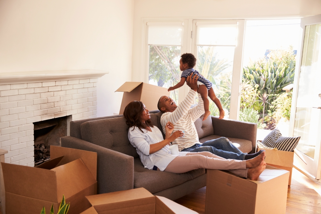 Young Couple With Baby Moving Into New Home